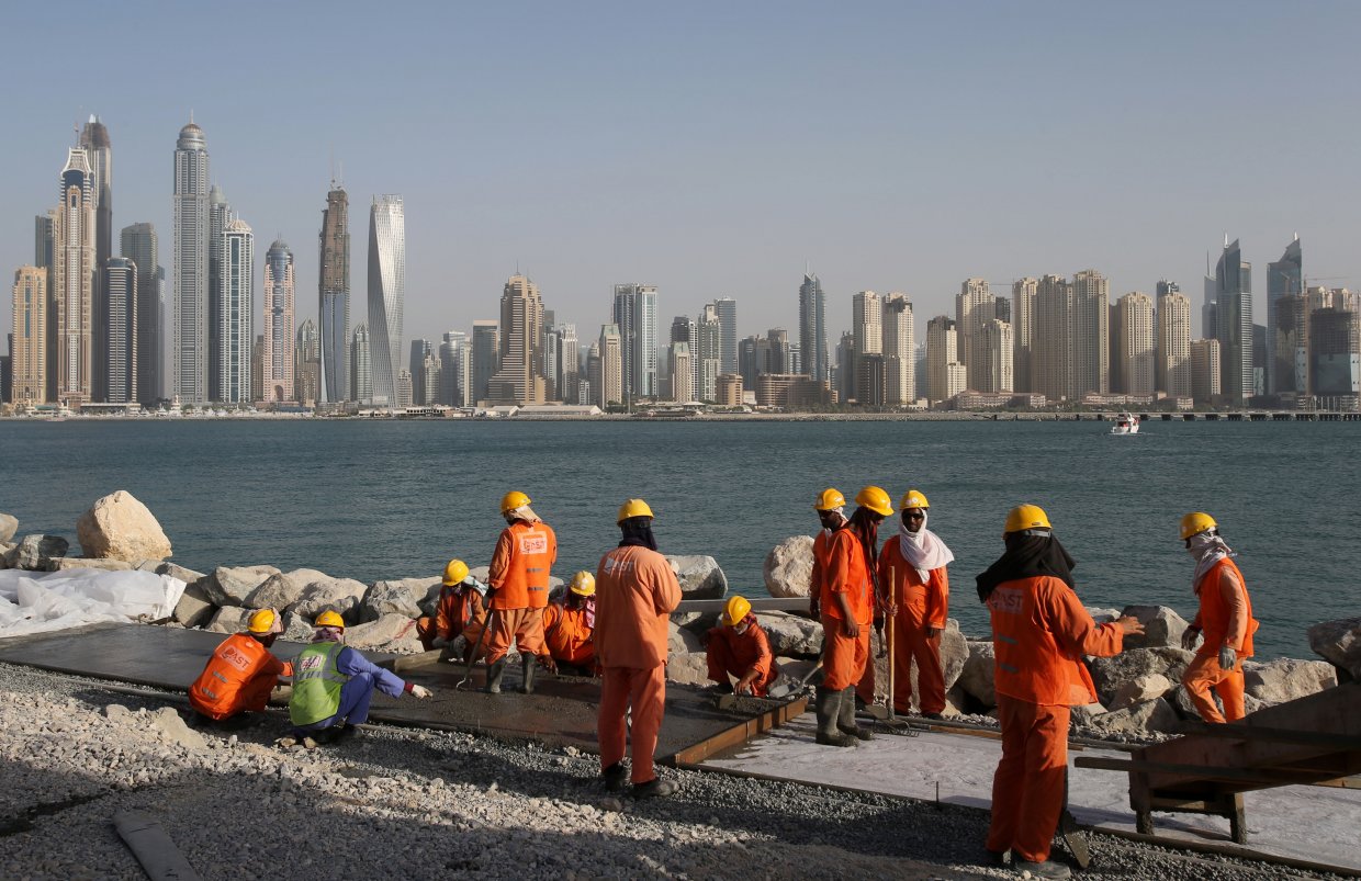 Migrant workers in Dubai, United Arab Emirates. Migrant workers often live and work under very precarious conditions in the oil-rich states of the Persian Gulf.